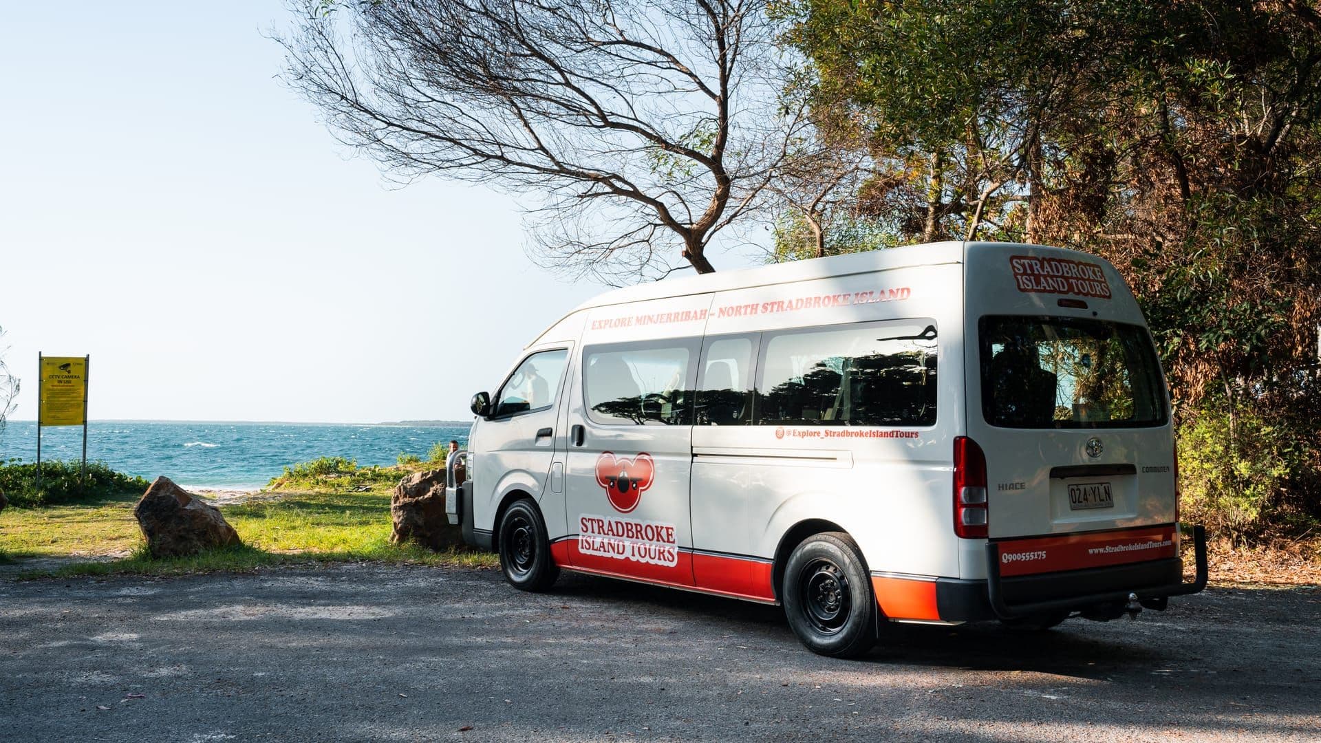 Branded Stradbroke Island Tours minibus parked at a coastal lookout on North Stradbroke Island