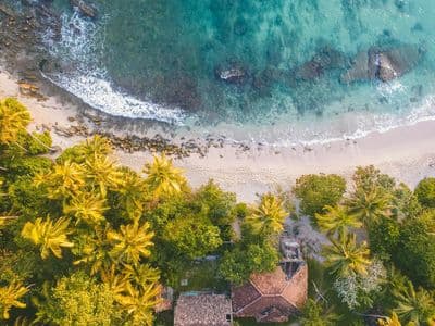 Wide golden sand beach under a clear blue summer sky